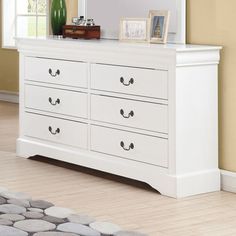 a white dresser and mirror in a room