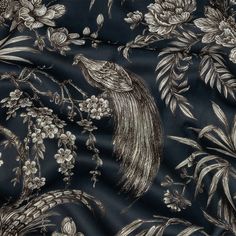 an image of a black and white fabric with floral designs on the back, featuring a bird in flight