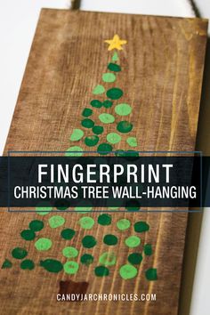 fingerprint christmas tree wall hanging made out of wood planks with green paint on it