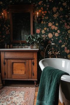 a bath tub sitting next to a wooden cabinet in a room with floral wallpaper