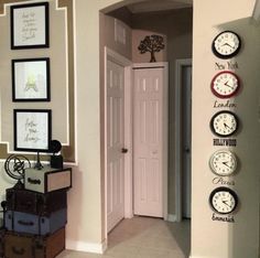 there are many clocks on the wall in this hallway, along with other things to do