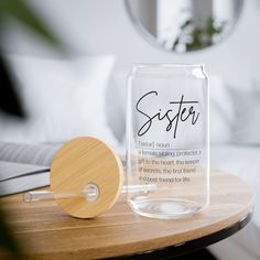 a glass jar sitting on top of a table next to a wooden paddle and mirror