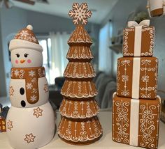 two snowmen made out of gingerbreads sitting next to each other on a table