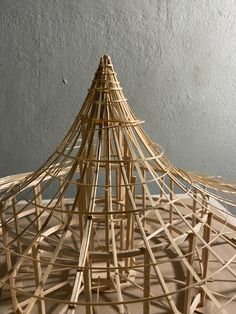 a wooden structure made out of sticks on top of a table