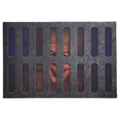 an image of a woman behind bars on a black mat with blue and red stripes