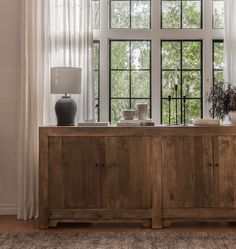 a large wooden cabinet sitting in front of a window