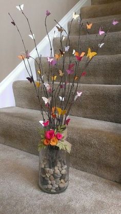 a vase filled with flowers sitting on top of a carpeted stair case next to a set of stairs