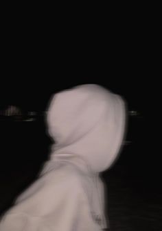 a blurry image of a person wearing a white hoodie