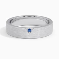 a white gold ring with a blue sapphire stone in the center