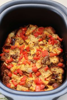 a casserole dish with tomatoes and meat in it