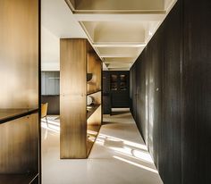 an empty hallway with wooden partitions in the middle