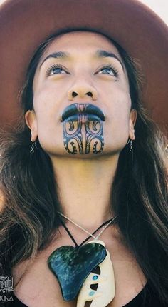 a woman with her face painted like a man's mustache and moustache