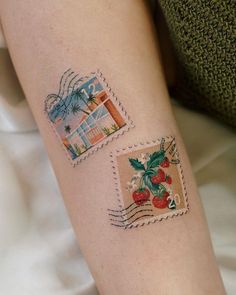 a woman's arm with a postage stamp and strawberrys on the inside of it