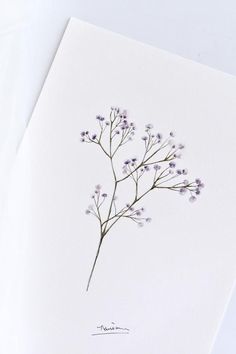 a white card with purple flowers on it