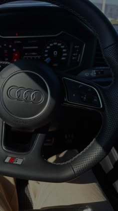 the steering wheel and dashboard of an automobile