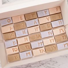 a box filled with lots of different types of letters on top of a marble counter