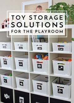 toy storage solution for the playroom with white bins filled with toys and books