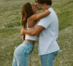 a man and woman kissing in a field