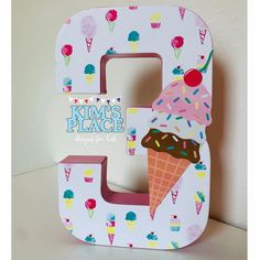 the letter e is decorated with ice cream and sprinkles