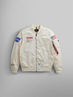 Show off your intergalactic style with this lightweight version of our popular NASA flight jacket, complete with NASA and American flag patches. It’s water resistant and comes in two space-inspired colors, replica blue and off white, for that authentic astronaut look. A flight jacket with NASA logo patches. DETAILS A flight jacket with NASA logo patches. FEATURES NASA worm logo rubber patch on wearer's right Two exterior welt pockets Two interior welt pockets Knit cuff, collar, and waistband Utility sleeve pocket with Alpha red ribbon American flag patch on wearer's left sleeve Alpha label at bottom hem MODEL INFORMATION: White Variant Model: Height: 6'4” Size: Large Replica Blue Variant Model: Height: 6’ 2” Size: Large Nasa Costume, Nasa Merch, Nasa Jacket, Nasa Clothes, American Flag Patch, Nasa Logo, Flight Suit, Rubber Patch, Flag Patches