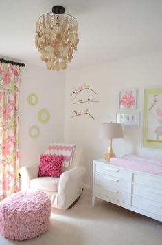 a bedroom decorated in pink and white with polka dots on the walls, two twin beds are next to each other