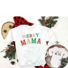 A matching duo! Merry Mama + Merry Mini - cute family matching this holiday season for moms and kids of any age! ✨Details✨ Product Options: Adult Crewneck Sweatshirt (White) - Gildan 18500 Adult Short Sleeve T-shirt (White) - Bella + Canvas 3001 Youth Short Sleeve T-shirt (White) - Bella + Canvas 3001Y Toddler Short Sleeve T-shirt (White) - Bella + Canvas 3001T Infant Longsleeve Bodysuit (White) - Rabbit Skins 4400 Infant Short Sleeve Bodysuit (White) - Rabbit Skins 4411 Please message me if you would like a different product type or color, and I will try my best to make it happen!  ✨Colors✨ ➤ Please see colors in listing photos. If you would like your design on a color that is not offered, message us and we will try to make it happen. ➤ Shirt colors may appear slightly different on differ Mama Merry, Mama And Mini, Matching Christmas Shirts, Bodysuit White, Mom And Me, Sweatshirt White, Christmas Mom, Baby's First Christmas, Mini Christmas