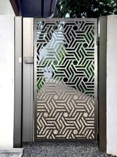 an open metal door with geometric designs on it