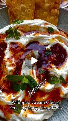 an appetizer with whipped cream cheese, feta dip and honey on it