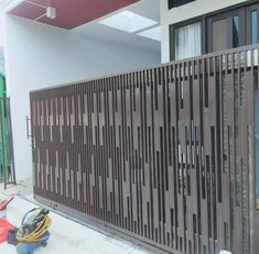 a metal fence is shown in front of a building with many wires on the ground