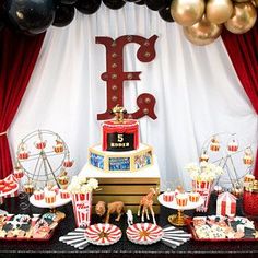 a circus themed birthday party with black, gold and white balloons in the shape of letters