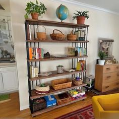 a living room filled with furniture and lots of books