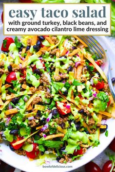 a white bowl filled with taco salad on top of a table