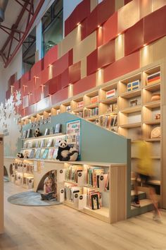 a child's room with bookshelves and shelves filled with children's books