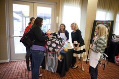 a group of women standing around a table