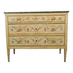 an antique chest of drawers with painted designs