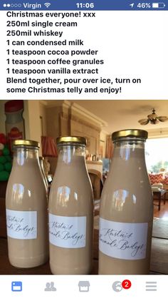 three bottles with labels on them sitting on a table