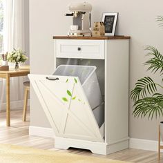 a white cabinet with an open door that has plants growing out of it and a potted plant next to it