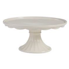 a white cake plate sitting on top of a table