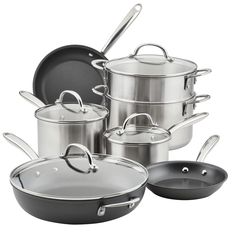 an assortment of pots and pans on a white background with the lid open to show them