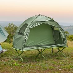 two tents are set up in the grass