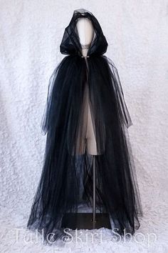 a mannequin wearing a black veil and cape