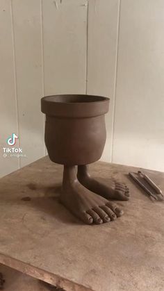 a clay pot sitting on top of a wooden table