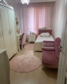 a bedroom with pink furniture and white walls