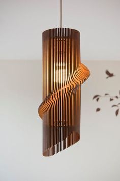 a wooden light fixture hanging from a ceiling in a room with birds flying around it