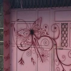 a painting on the side of a building with flowers and butterflies painted all over it