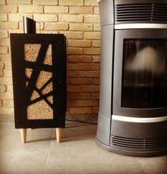 two stoves sitting next to each other in front of a brick wall and floor