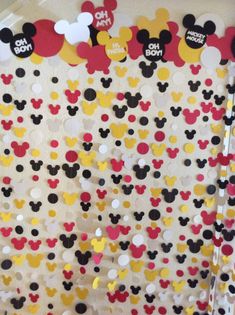 the mickey mouse bulletin board is decorated with many different colors and shapes, including red, yellow, black, and white