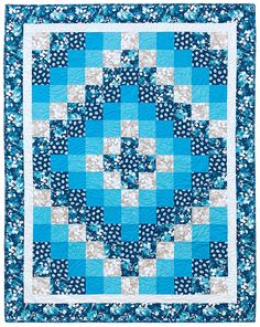 a blue and white quilted wall hanging