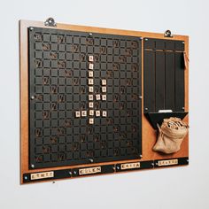 a wooden board with numbers on it and a bag hanging from the wall next to it