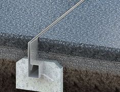 an image of a concrete block with water coming out of it and the ground below